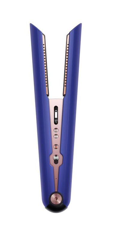 Woman with the Dyson Supersonic hair dryer with the diffuser attachment. 